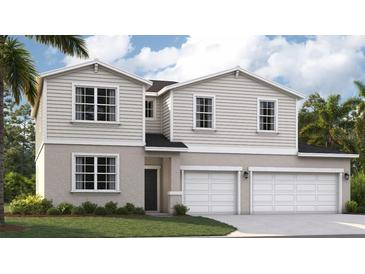 Charming two-story home with a two-car garage, landscaped yard, and neutral color scheme at 1343 Wood Line Dr, Deland, FL 32720