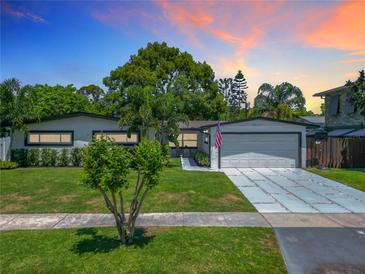Charming single Gathering home featuring a well manicured lawn and modern driveway at 2817 Prince John Rd, Winter Park, FL 32792
