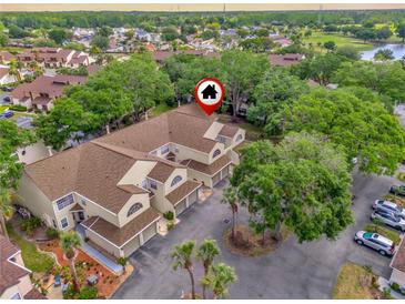 Charming townhouse exterior featuring a well-maintained roof and garages in a serene neighborhood at 6147 Sunnyvale Dr # Ge, Orlando, FL 32822