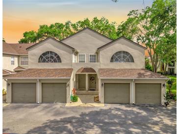 Inviting townhome with arched entry, multiple garages and lush landscaping for enhanced curb appeal at 6147 Sunnyvale Dr # Ge, Orlando, FL 32822
