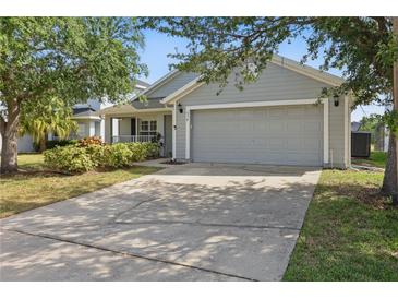 Charming single-story home featuring a gray exterior, two-car garage, and well-maintained landscaping at 634 Chadbury Way, Kissimmee, FL 34744