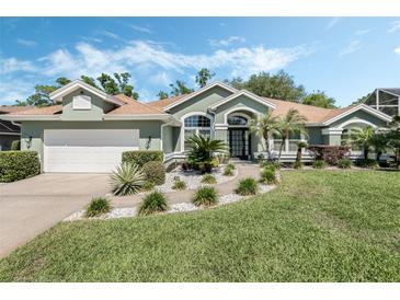 Charming single-story home with a manicured lawn, beautiful landscaping, and inviting curb appeal at 907 Ridge Spring Ct, Apopka, FL 32712