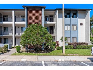 Attractive three-story condo building featuring balconies and a brick accent wall at 11 Escondido Cir # 110, Altamonte Springs, FL 32701
