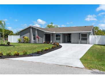 Charming single-story home featuring fresh landscaping, a long concrete driveway, and a freshly painted exterior at 116 Alcala Dr, Kissimmee, FL 34758
