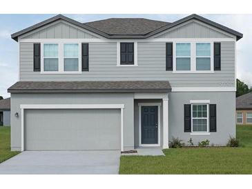 Charming two-story home featuring a neutral color scheme, a two-car garage, and well-maintained landscaping at 1391 Dalkeith Cv, Sanford, FL 32771