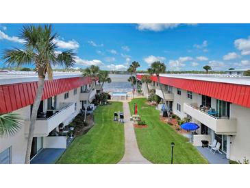 Beautiful condominiums with a pool near the water and lush green grass at 2901 N Halifax Ave # 220, Daytona Beach, FL 32118