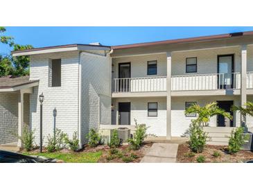 Charming two-story condo with white brick and a well maintained landscaped yard at 2912 Plaza Terrace Dr # 2912, Orlando, FL 32803