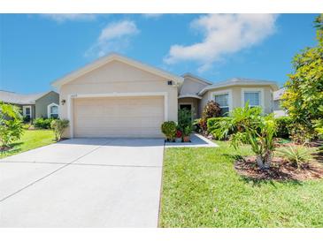 Charming single-story home with a well-manicured lawn and two-car garage on a sunny day at 3679 Julius Estates Blvd, Winter Haven, FL 33881