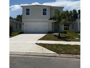 Charming two-story home with a well-manicured lawn and a two-car garage at 978 Commons Way, Port Orange, FL 32129