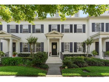 Charming two-story townhome with black shutters, a well-manicured lawn, and a welcoming entrance at 984 Fern Ave, Orlando, FL 32814
