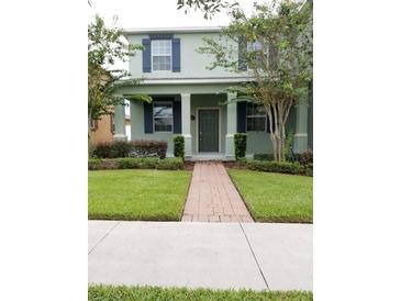Charming two-story home with a well-maintained lawn and inviting entryway at 14867 Driftwater Dr, Winter Garden, FL 34787