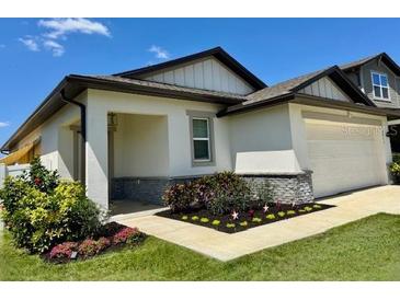 Charming home featuring a welcoming porch and well-manicured landscaping enhancing its curb appeal at 2075 Huntsman Ridge Rd, Clermont, FL 34715