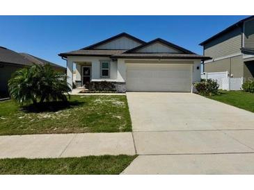 Charming single-story home with a well-manicured lawn and two-car garage at 2075 Huntsman Ridge Rd, Clermont, FL 34715
