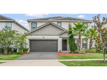 Charming two-story home with a well-manicured lawn and two car garage at 2616 Calistoga Ave, Kissimmee, FL 34741