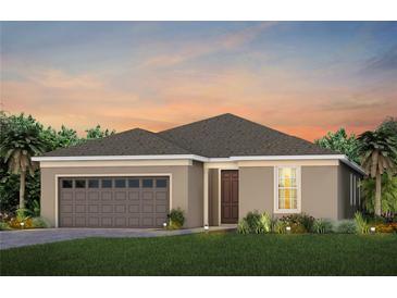 Charming single-story home with neutral stucco, brown accents, and attached two car garage at 2741 Serenity Meadow Dr, Kissimmee, FL 34744