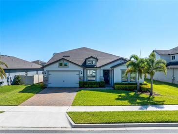 Charming single-Gathering home with a well-manicured lawn, brick driveway and a two-car garage at 327 Island Sound Ct, Longwood, FL 32779