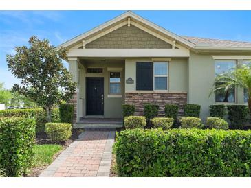 Charming single-story home featuring a well-maintained lawn and lovely landscaping at 10006 Quail Meadow Aly, Winter Garden, FL 34787