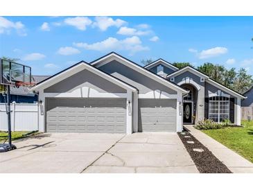 Charming home featuring a three-car garage, neutral color palette and a basketball hoop at 1008 W Riviera Blvd, Oviedo, FL 32765