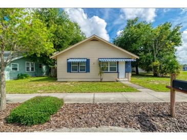 Charming single-story home featuring a well-maintained lawn and pleasant landscaping at 111 E Caroline St, Tavares, FL 32778