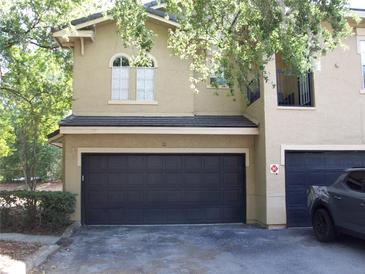 Two-story home with a two-car garage and a well-maintained lawn at 143 Villa Di Este Ter # 205, Lake Mary, FL 32746