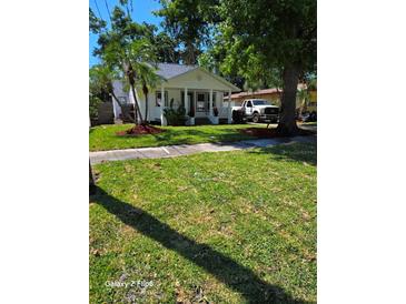 Charming one-story home featuring a manicured lawn, well-kept landscaping, and welcoming front porch at 2114 Gerda Ter, Orlando, FL 32804
