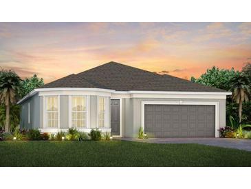 Charming one-story home featuring a gray exterior, two car garage, and well-maintained lawn at 2737 Serenity Meadow Dr, Kissimmee, FL 34744
