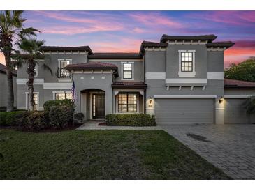 Stunning two-story home featuring a tile roof, manicured lawn, and two-car garage at 2860 Falconhill Dr, Apopka, FL 32712