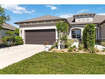 Charming home featuring a landscaped front yard, a neutral color palette, and a two-car garage at 3295 Bailey Ann Dr, Ormond Beach, FL 32174