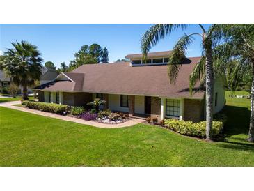 Charming single-story home with well-manicured lawn, mature trees, and beautiful landscaping at 4464 Willow Wind Ct, Orlando, FL 32835