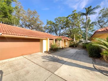 Property with a terracotta roof, a paved driveway, and a two-car garage at 5037 Bermuda Cir # 10, Orlando, FL 32808