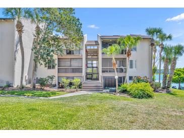 Beautiful condo building with lush landscaping and staircase access to upper units at 574 Orange Dr # 78, Altamonte Springs, FL 32701