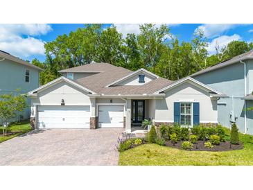 Charming home with a well-manicured lawn, a two-car garage, and a beautifully landscaped front yard at 1005 Talon Pl, Winter Springs, FL 32708