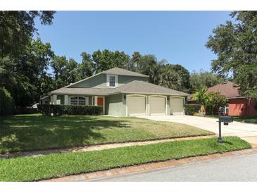 Charming home featuring a three-car garage and well-maintained lawn at 1101 N Division St, Oviedo, FL 32765