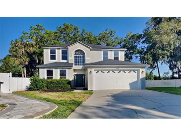 Charming two-story home with a manicured lawn and a two-car garage at 130 Circle Hill Rd, Sanford, FL 32773