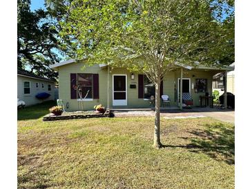 Charming single-story home featuring a well-maintained lawn and cozy front porch, perfect for relaxing outdoors at 1404 Davidson St, Orlando, FL 32804
