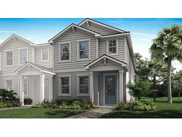 Charming two-story home with a landscaped yard and inviting blue front door at 3189 Douglas Fir Dr, Apopka, FL 32703
