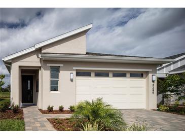 Attractive one-story home with a two-car garage and a stylish, low-maintenance landscaped front yard at 3289 Songbird Cir, Harmony, FL 34773