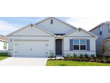 Charming single-story home with a two car garage, landscaped front yard, and a welcoming entrance at 33455 Copper Hill Way, Sorrento, FL 32776