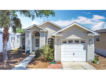 Charming single-story home featuring a one-car garage and well-maintained landscaping at 50989 Highway 27 # 174, Davenport, FL 33897