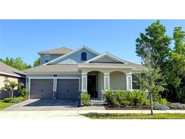 Charming two-story home with a well-manicured lawn, covered porch, and an attached two-car garage at 750 Porter Rye Ave, Debary, FL 32713