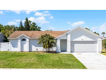 Charming single-story home with a well-manicured lawn and a neatly paved driveway at 996 Big Oaks Dr, Oviedo, FL 32765