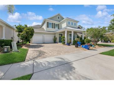 Charming two-story home with a beautifully landscaped yard and a three-car garage at 8778 Peachtree Park Ct, Windermere, FL 34786