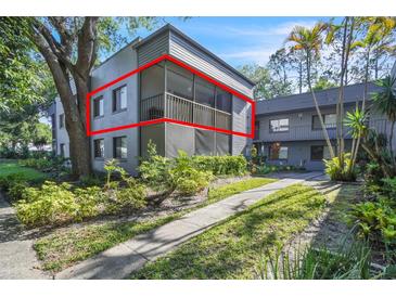 Attractive condo exterior with a screened patio in a lush landscaped setting at 2329 Oak Park Way # 204, Orlando, FL 32822