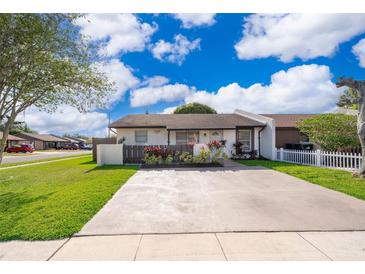 Charming single-story home with a well-maintained lawn and a quaint front garden at 3103 Yorych Ln, Orlando, FL 32822