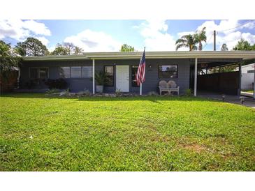 Charming single story home with beautiful landscaping and American flag at 5384 Barton Dr, Orlando, FL 32807