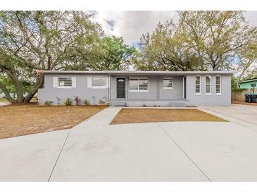 Charming single-story home with a well-maintained front yard and mature trees at 5500 Riviera Dr, Orlando, FL 32808