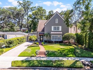 Charming two-story home featuring a manicured lawn and brick walkway leading to the front door at 910 Alameda St, Orlando, FL 32804