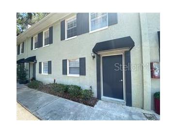 Two-story townhouse showing the front entry and garden area at 2141 Lake Margaret Dr # 11, Orlando, FL 32806