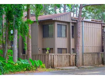 Inviting two-story home features a well-maintained yard and serene, woodsy surroundings at 5310 Pebble Beach Dr # 20, Orlando, FL 32811
