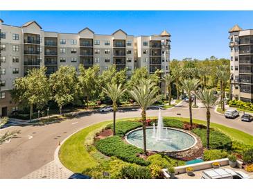 Upscale condominium with water fountain, lush greenery, and beautiful landscaping at 14501 Grove Resort Ave # 1441, Winter Garden, FL 34787
